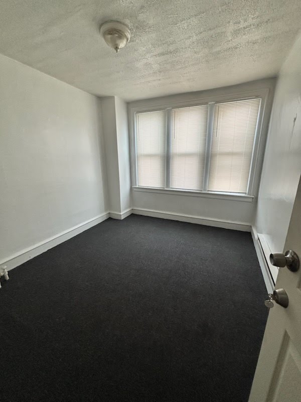 Bright private front room with three windows